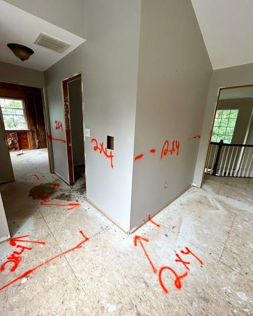 Interior with walls marked out in paint before selective demolition