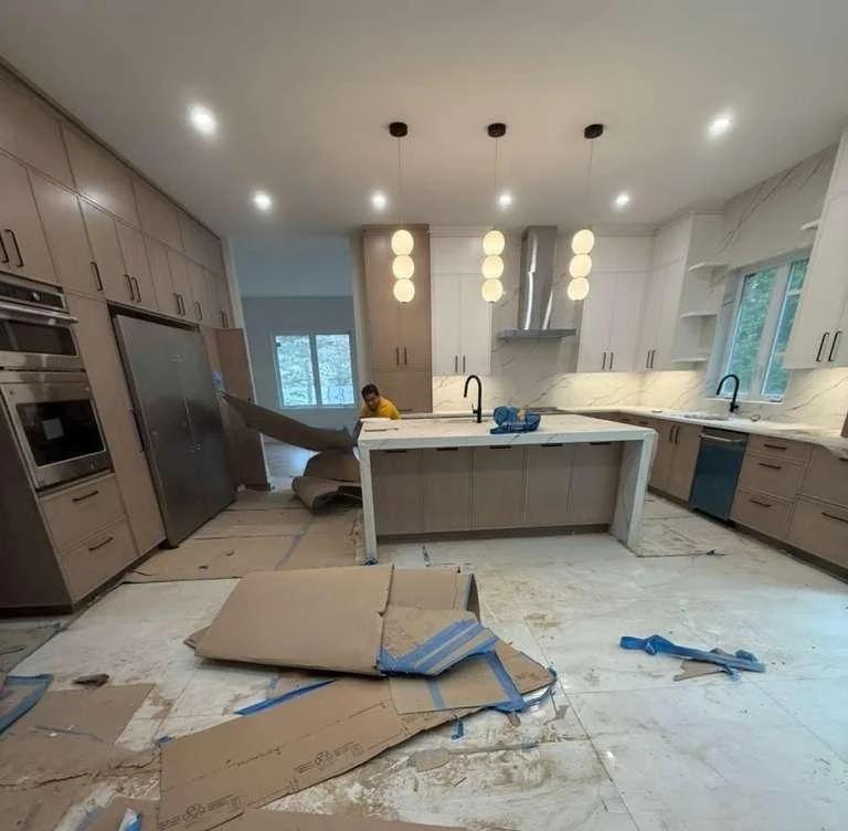 New kitchen with cardboard and dust before post-construction cleaning